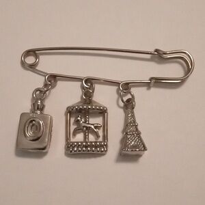 #763.  Silver Toned Safety Pin Articulated Carousel Charm Brooch
